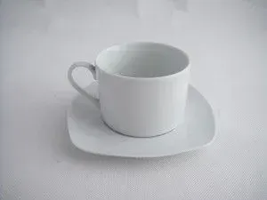 A white ceramic sugar bowl with a matching lid, decorated with a gold and silver floral patterned rim.