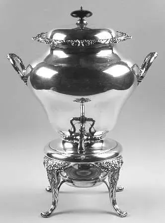 A two-tiered, curved reception desk with a light wood-grain finish and black fabric skirting on metal folding legs.