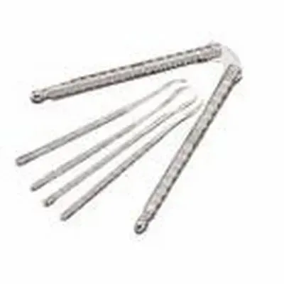 A nutcracker and three metal seafood picks on a white background.