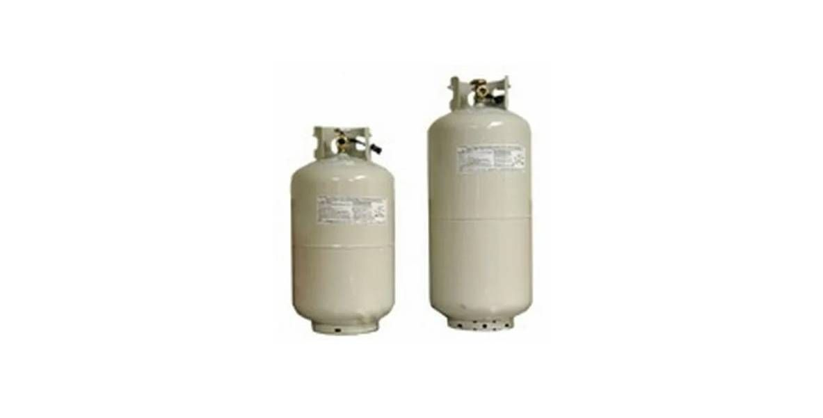 Two light-colored, cylindrical metal tanks with valves on top, standing side-by-side against a plain background.
