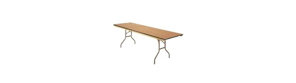 A rectangular folding table with a tan wood-grain surface and gray metal legs, shown from a high angle.