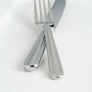 A silver fork and knife with a ribbed handle design resting crossed on a white background.