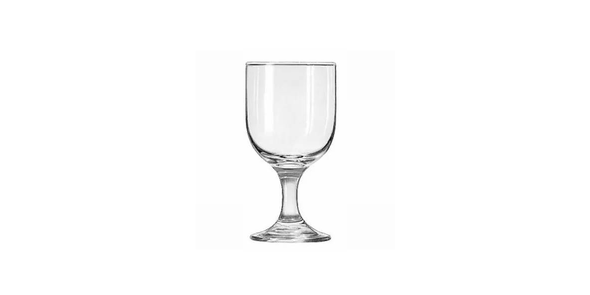A clear glass water goblet with a short stem and wide base, centered against a white background.