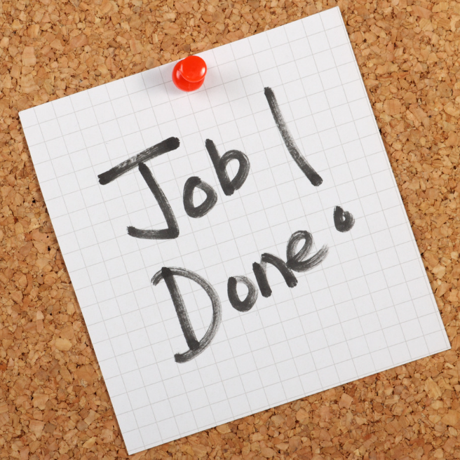 A note that says job done is pinned to a cork board