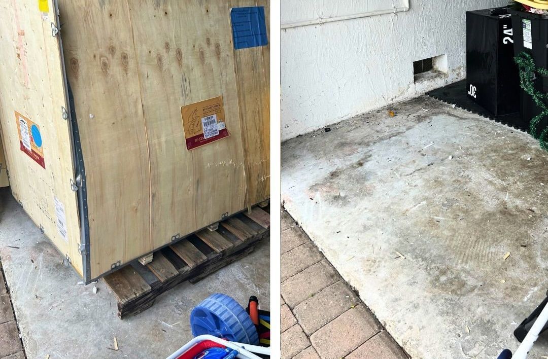 A wooden box is sitting on top of a pallet next to a concrete floor.