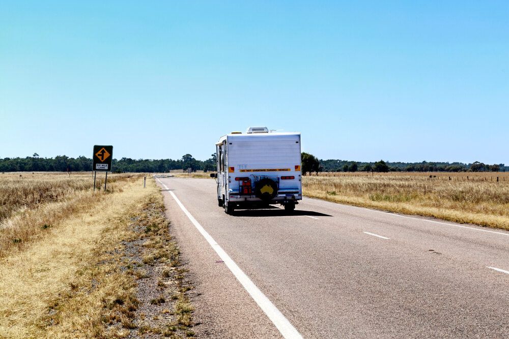 Caravan Driving Down Australian Road — Caravan Experts In The Charters Towers Region, QLD
