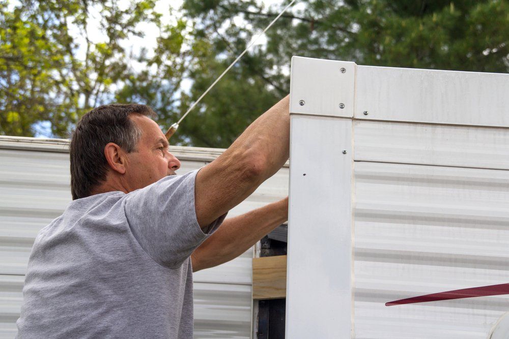 Worker Repairing Caravan — Caravan Experts In The Charters Towers Region, QLD