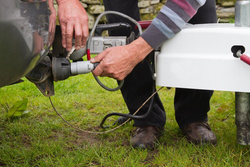 Man Fixing Caravan Connection Point — Caravan Experts In The Charters Towers Region, QLD