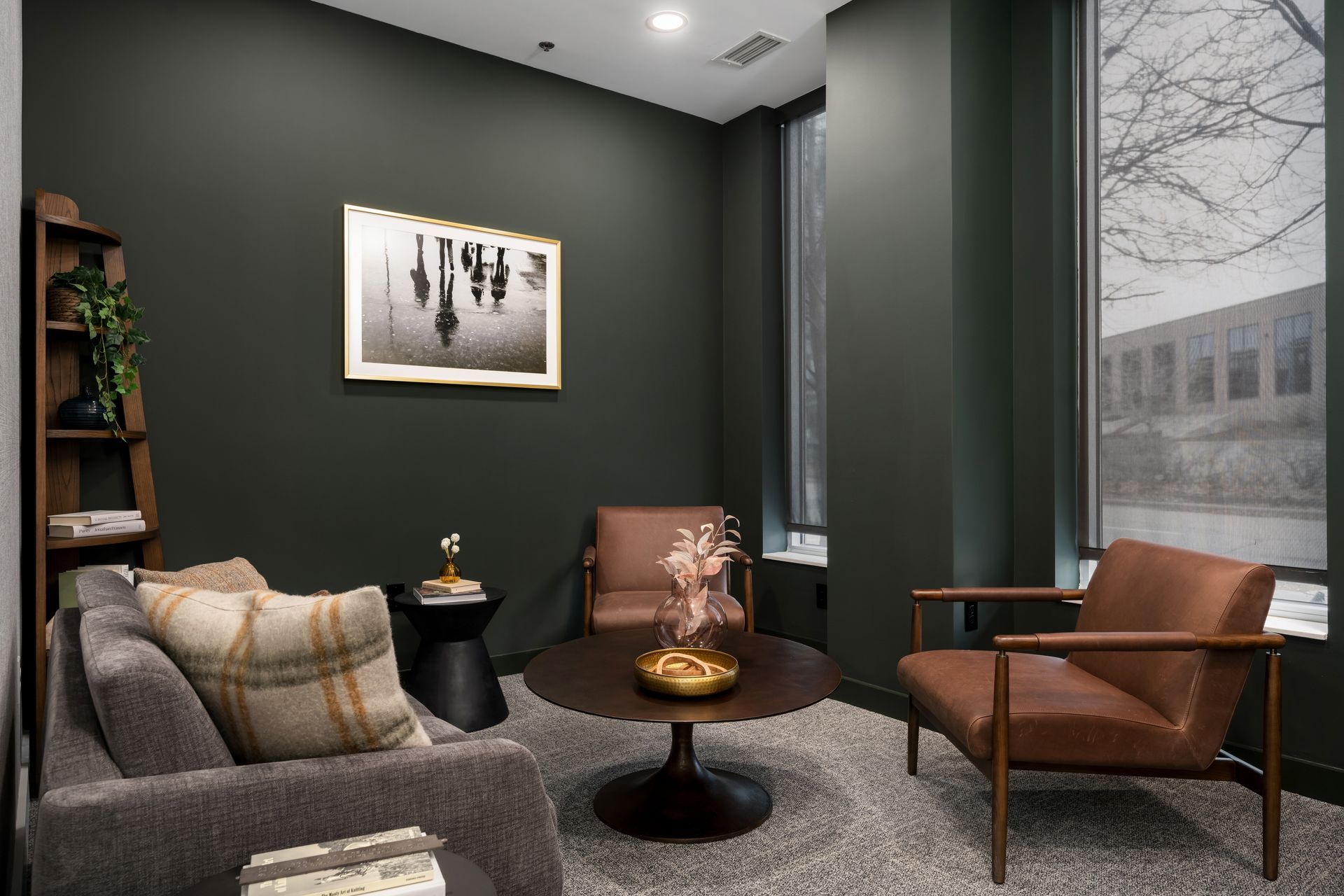 a living room with a couch , chairs , a coffee table and a picture on the wall .