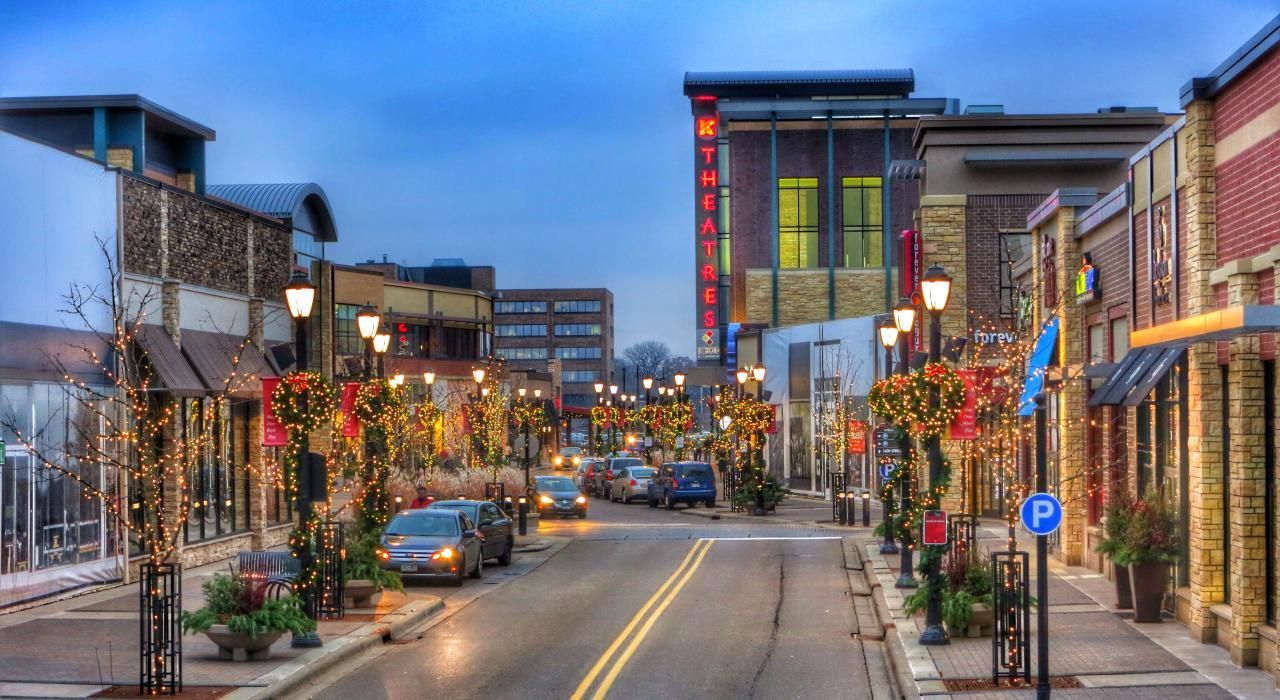 a city street with a lot of shops and cars on it .