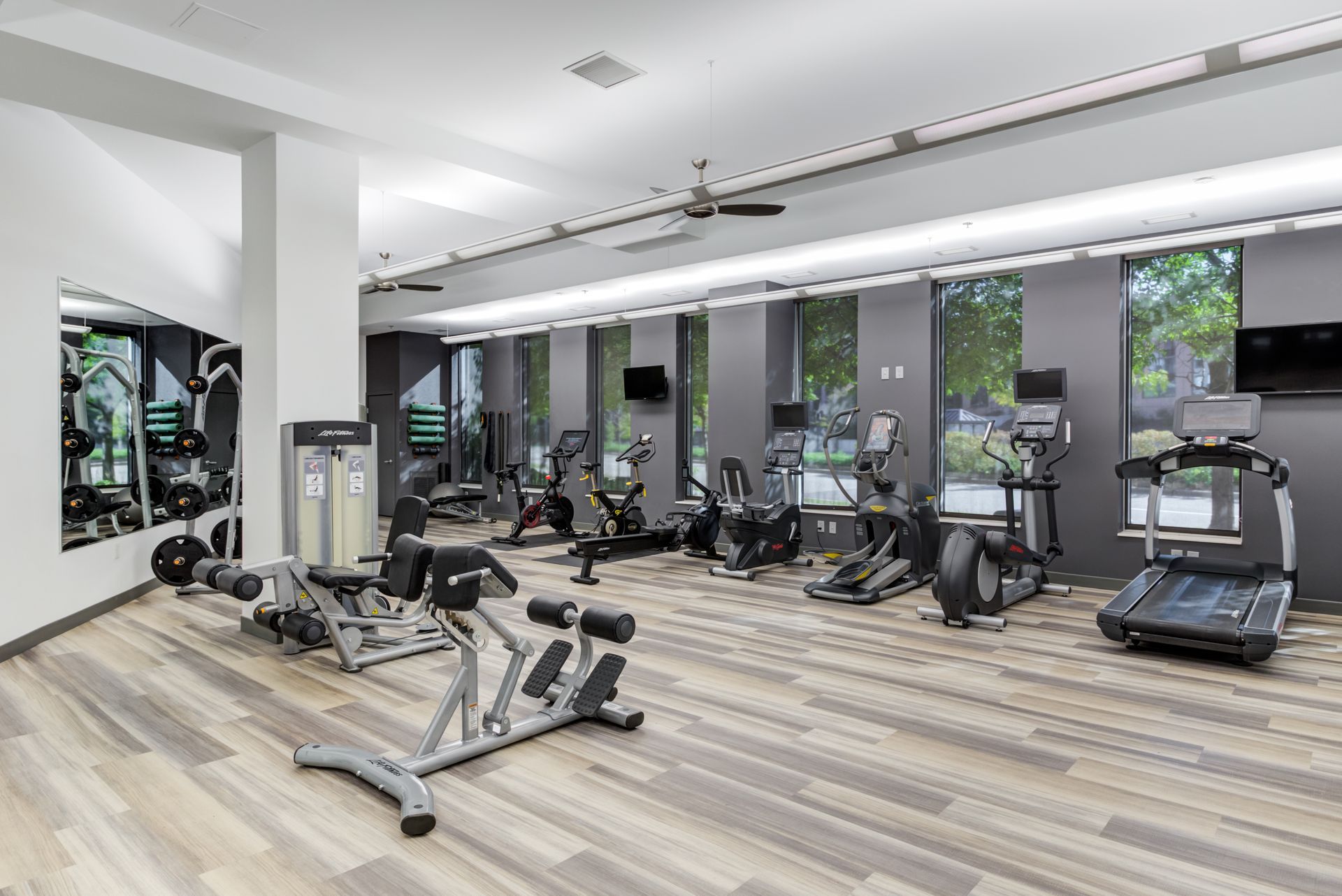 a large gym with a lot of exercise equipment and a treadmill .