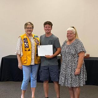 A group of people are standing next to each other in a room.