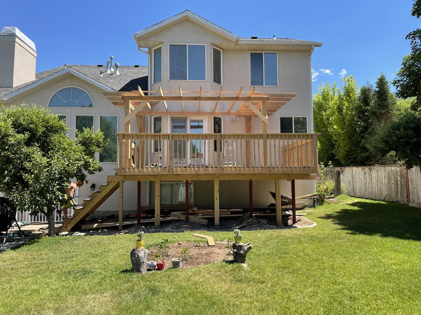 a large house with a wooden deck in the backyard .