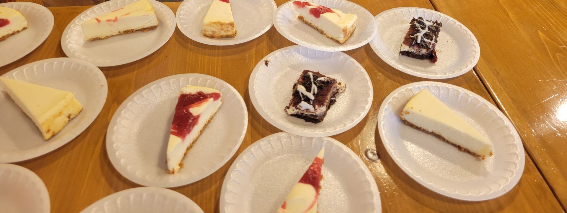 There are many different types of cheesecake on the plates.