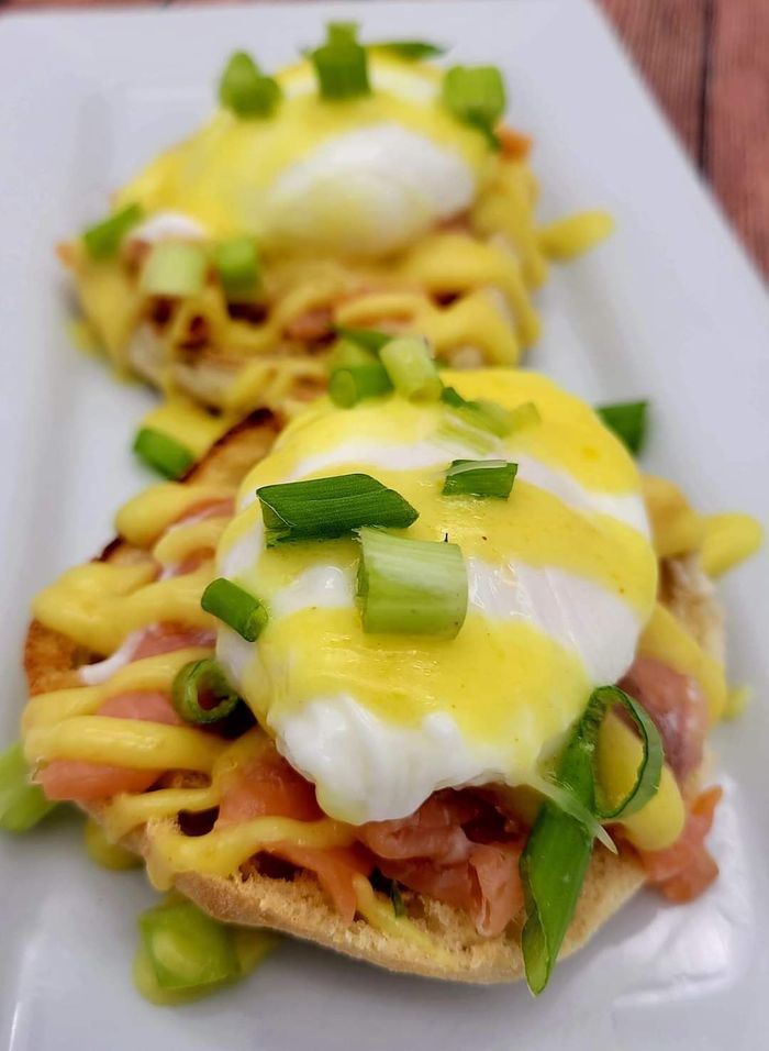 A close up of a plate of eggs on meat