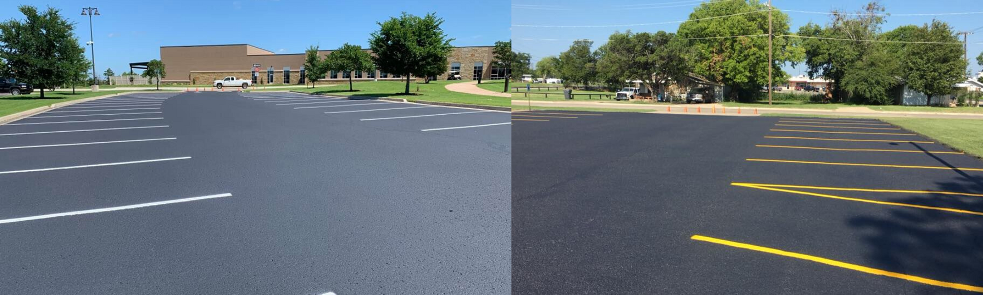 Empty parking lot with white and yellow painted spaces beside a low brick building and trees.