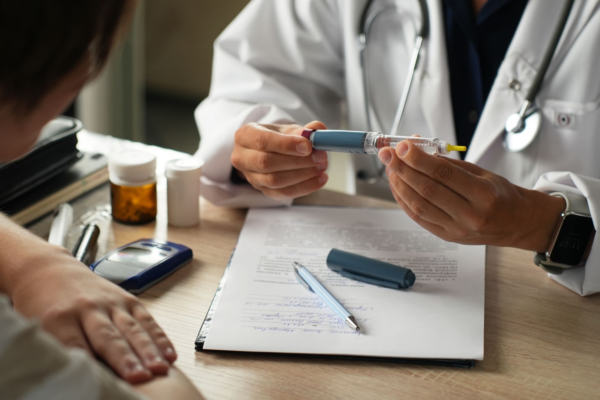Doctor preparing an injection for a patient at a desk, medical setting.