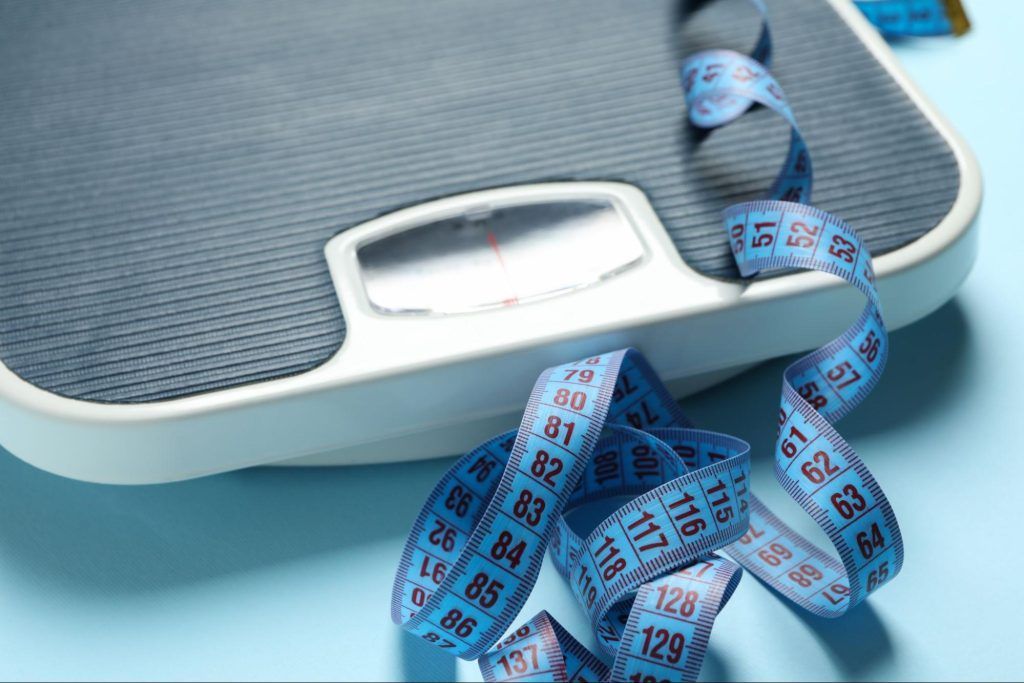 weighing scale and a blue tape measure