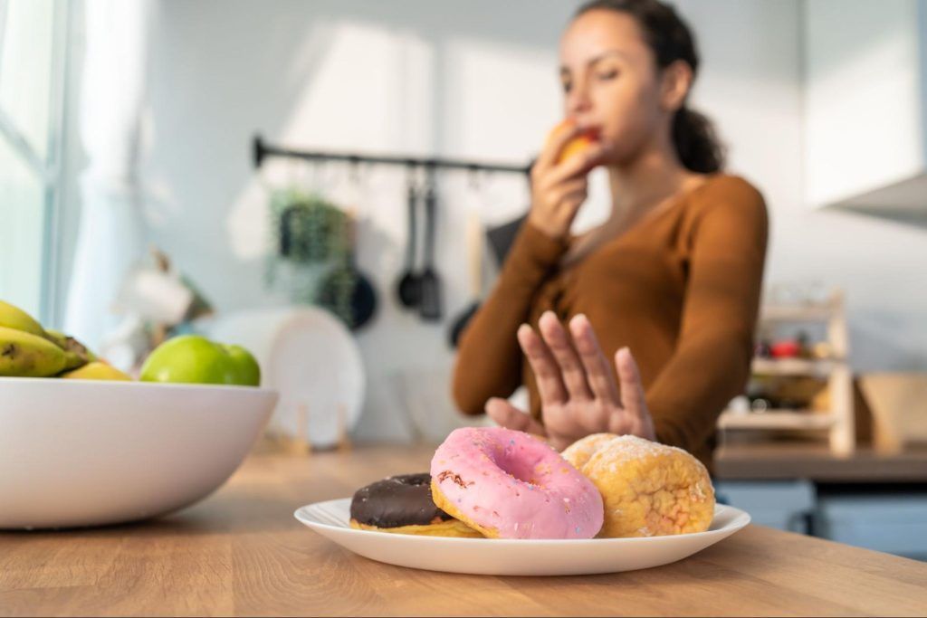 woman avoiding donuts
