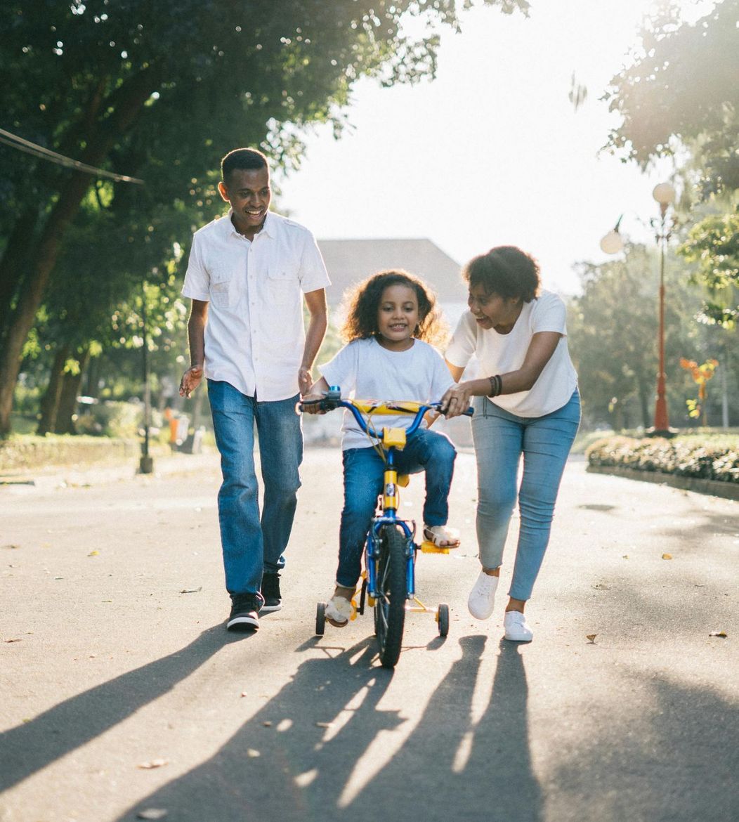 Two women holding a baby in front of a shed—clients of a reliable Houston law firm