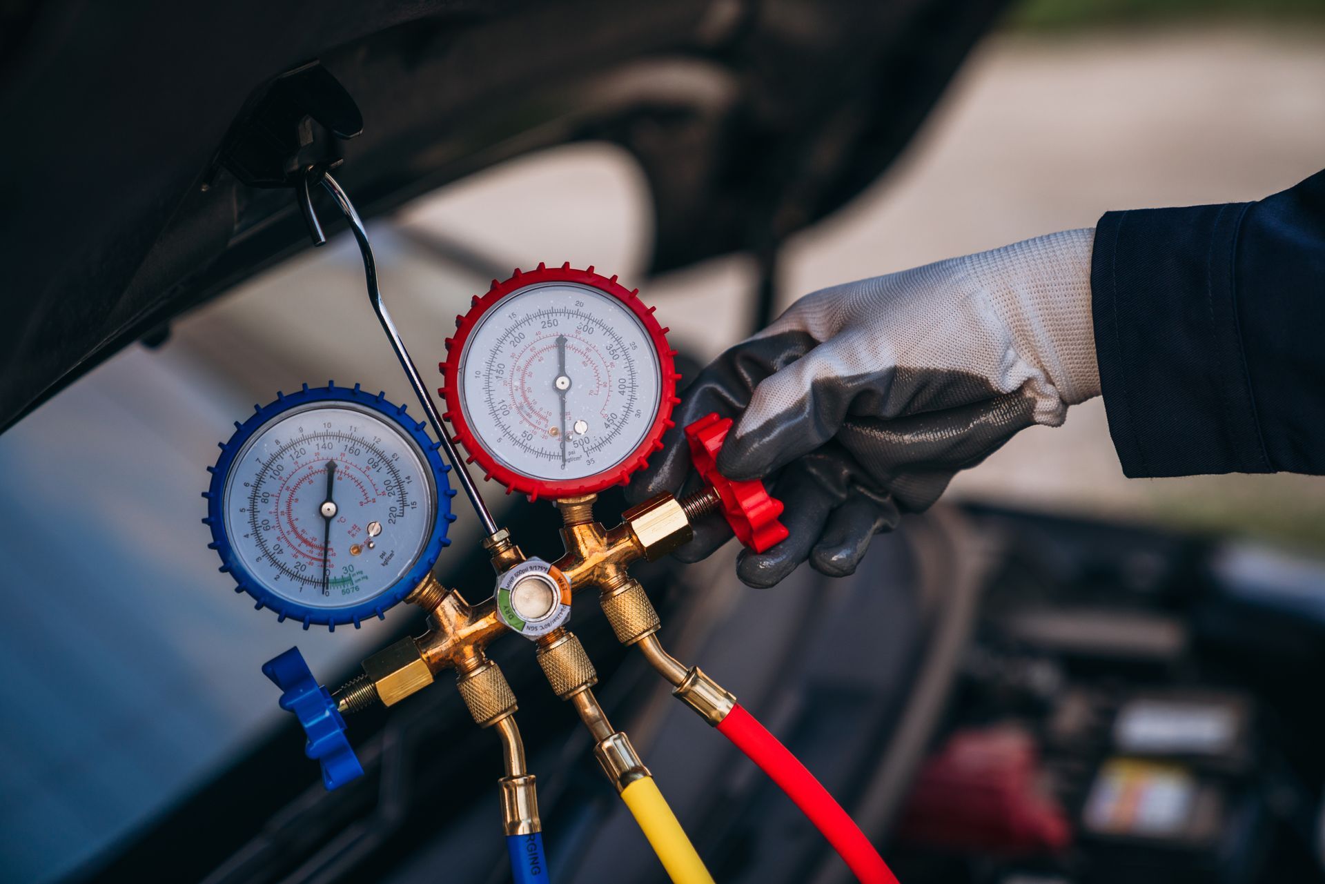 A person is working on an air conditioning system in a car.
