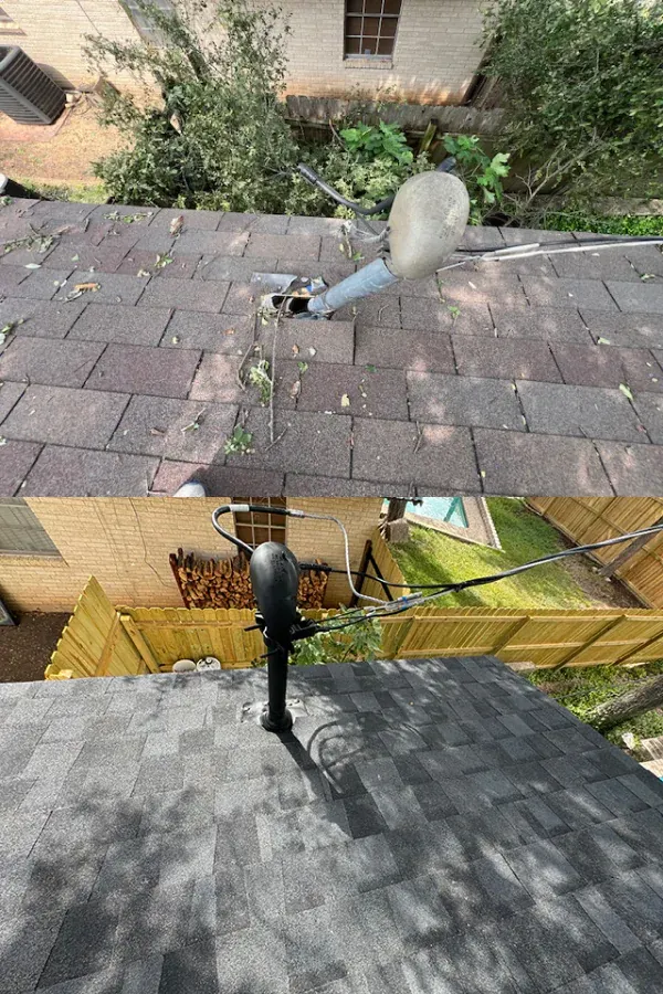 There is a satellite dish on the roof of a house.