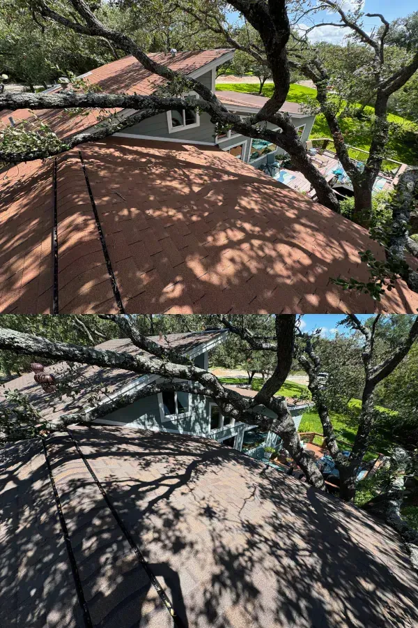 A house with a roof that has been damaged by a tree.