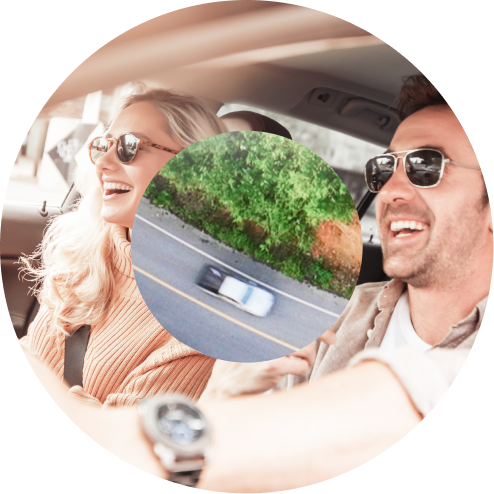 People in car driving with white car in center | Roe Jan Auto Center LLC