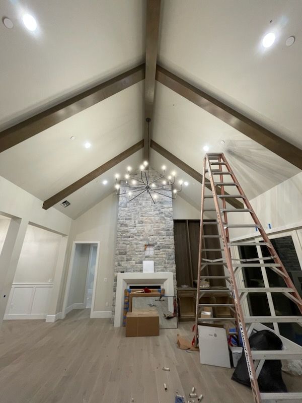 A living room with a vaulted ceiling and a ladder