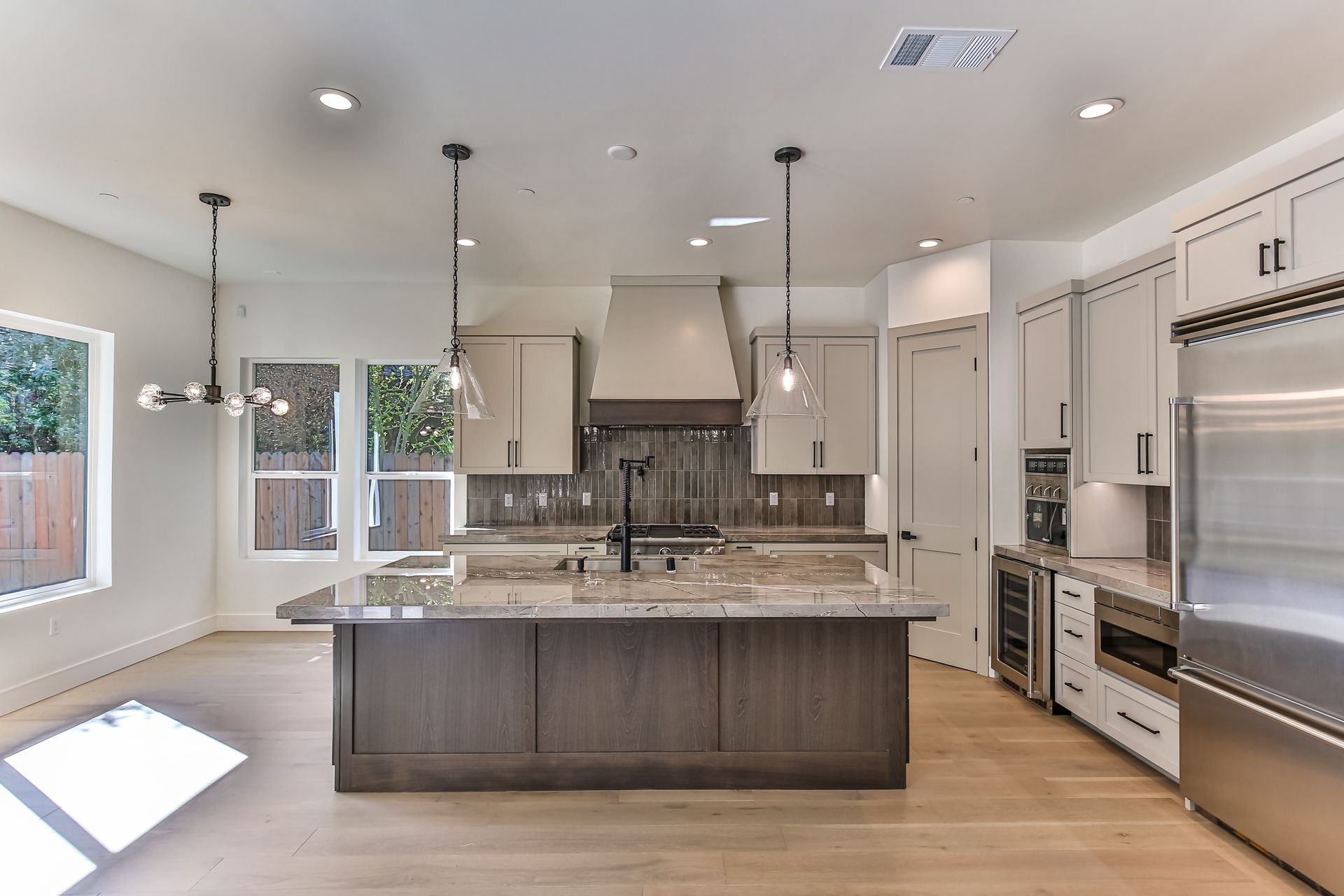 A kitchen with a large island and stainless steel appliances