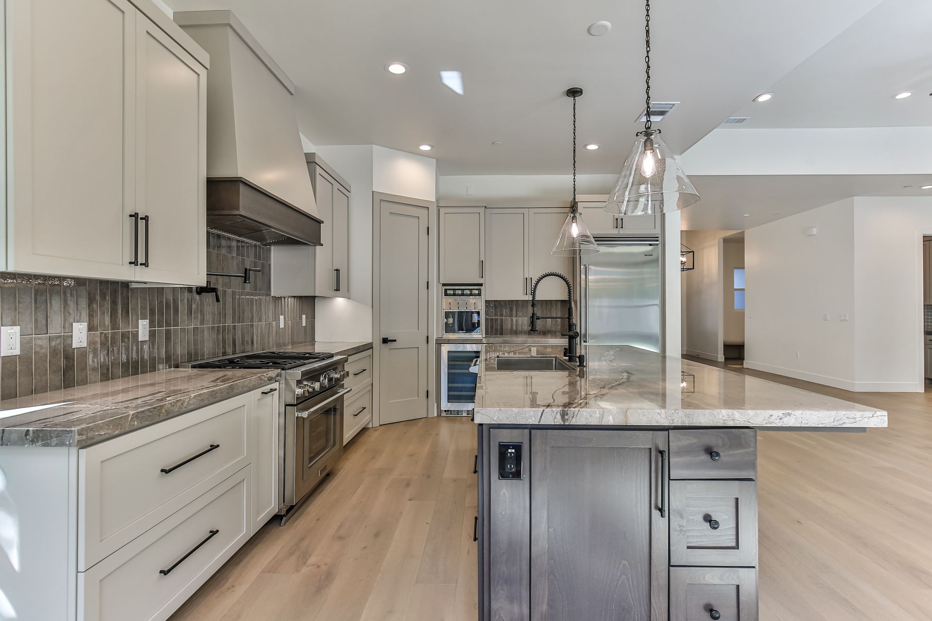 A kitchen with white cabinets and stainless steel appliances