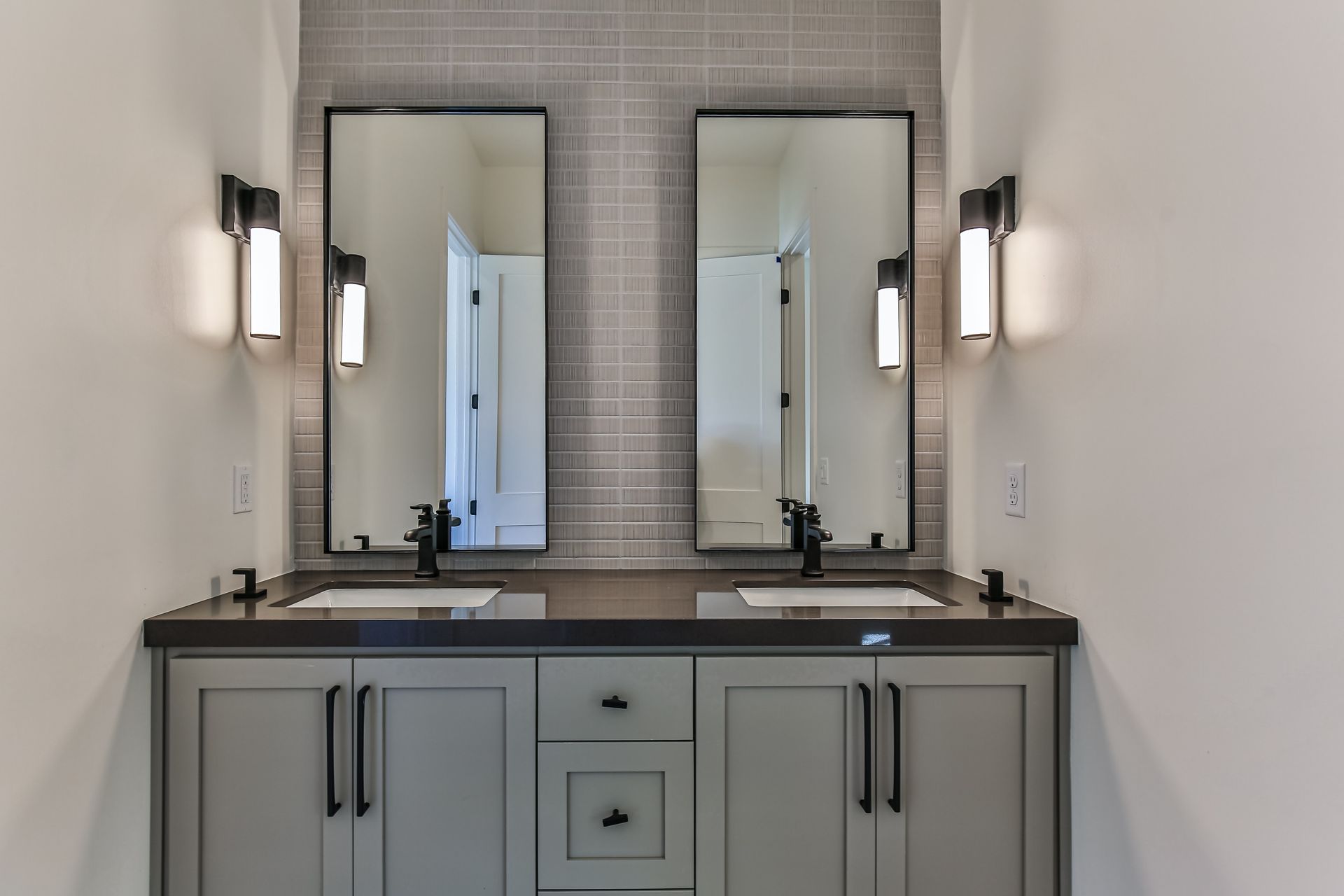 A bathroom with two sinks and two mirrors.
