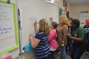 Students doing Math on whiteboard