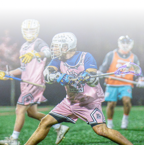 A group of men are playing lacrosse on a field.
