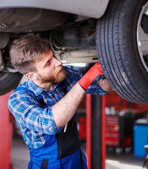 Mechanic Checking the Tire - Automotive Repair in Hillsborough, NC