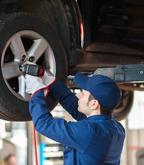 Mechanic Replacing the Wheel - Automotive Repair in Hillsborough, NC