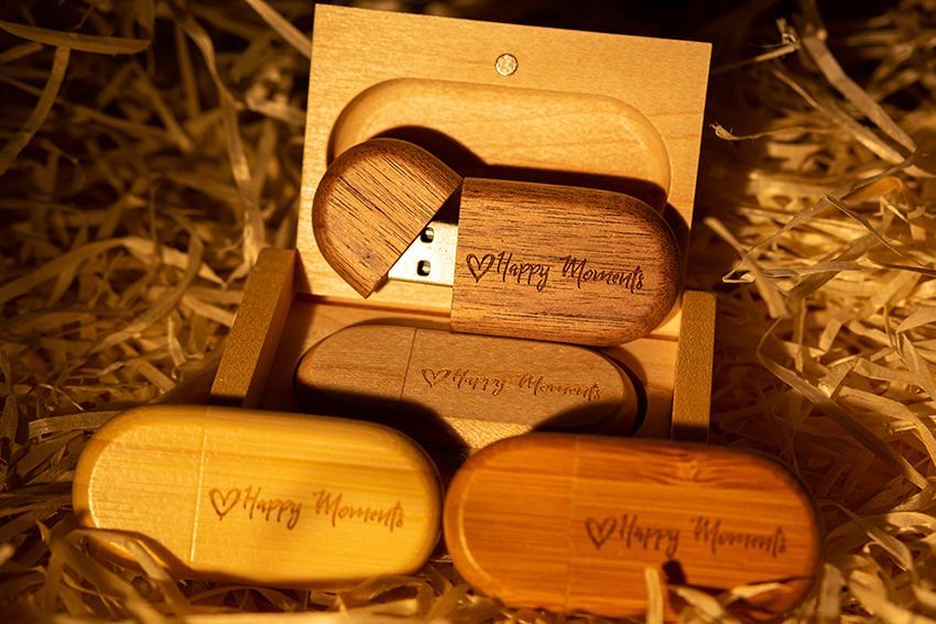 Three Wooden Flash Drives with the Words Happy Moments Engraved on Them — Ace Wholesale Trophies & Engraving In Moranbah, QLD