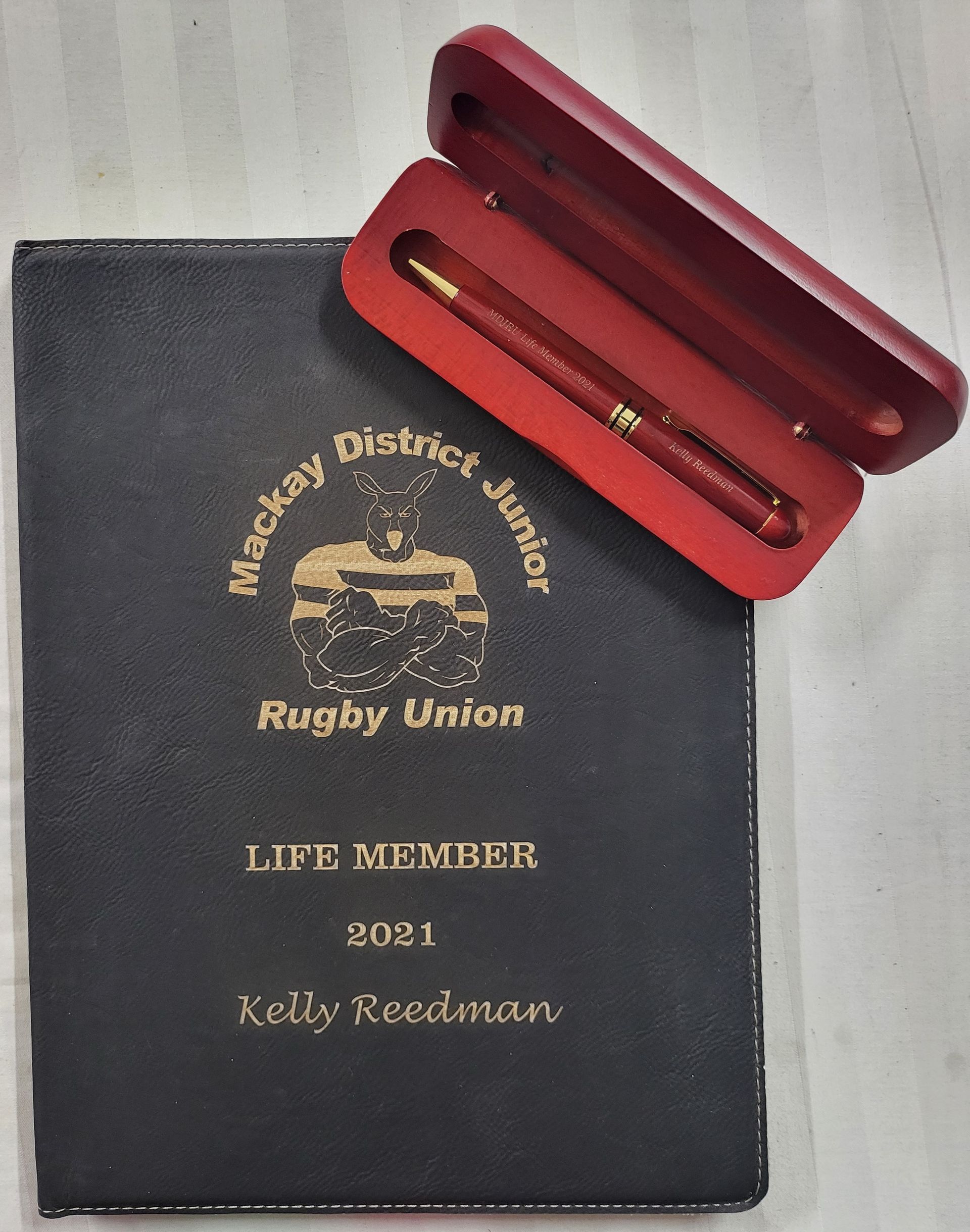 A Silver Star Trophy is Sitting on Top of a Clear Glass Block — Ace Wholesale Trophies & Engraving In Bowen, QLD