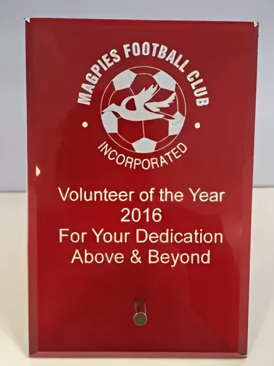 A Red Plaque That Says Volunteer of the Year 2016 — Ace Wholesale Trophies & Engraving In Moranbah, QLD