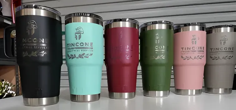 A Row of Stainless Steel Tumblers Are Lined Up on a Table — Ace Wholesale Trophies & Engraving In Proserpine, QLD