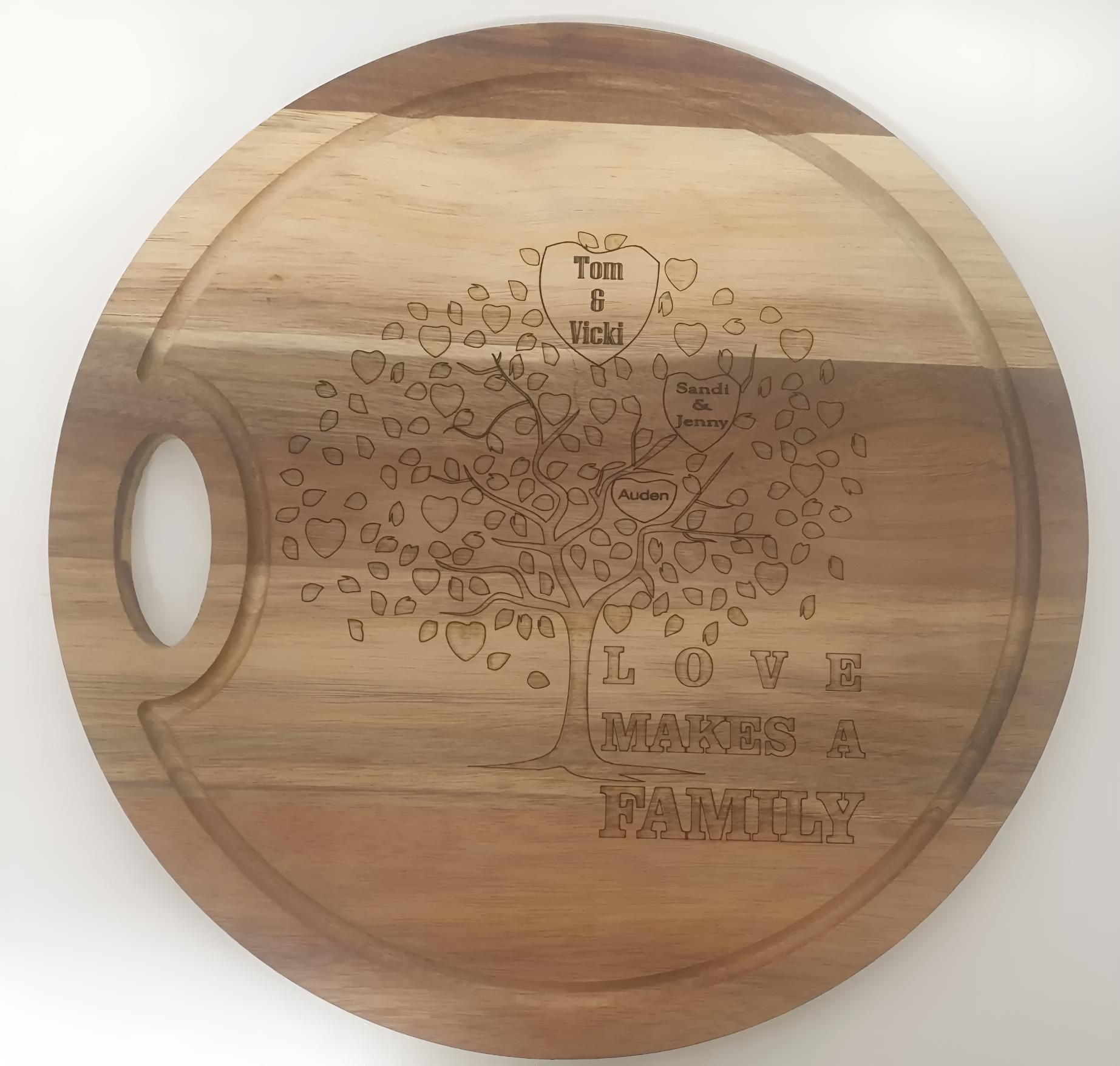 A Wooden Cutting Board That Says Loves Makes A Family — Ace Wholesale Trophies & Engraving In Bakers Creek, QLD
