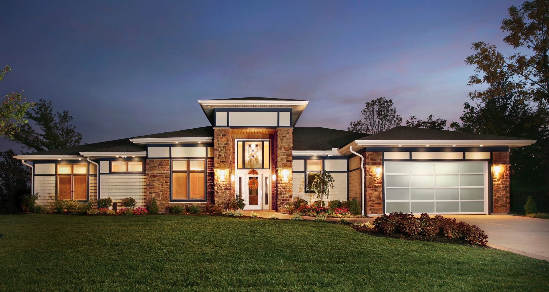 a large house with a brick facade and a glass garage door