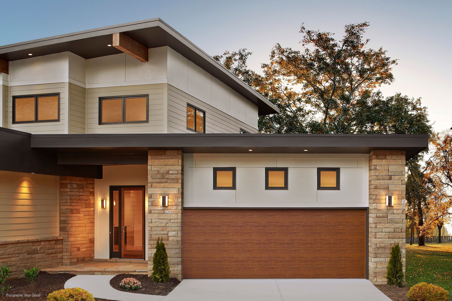 a modern house with a large wooden garage door