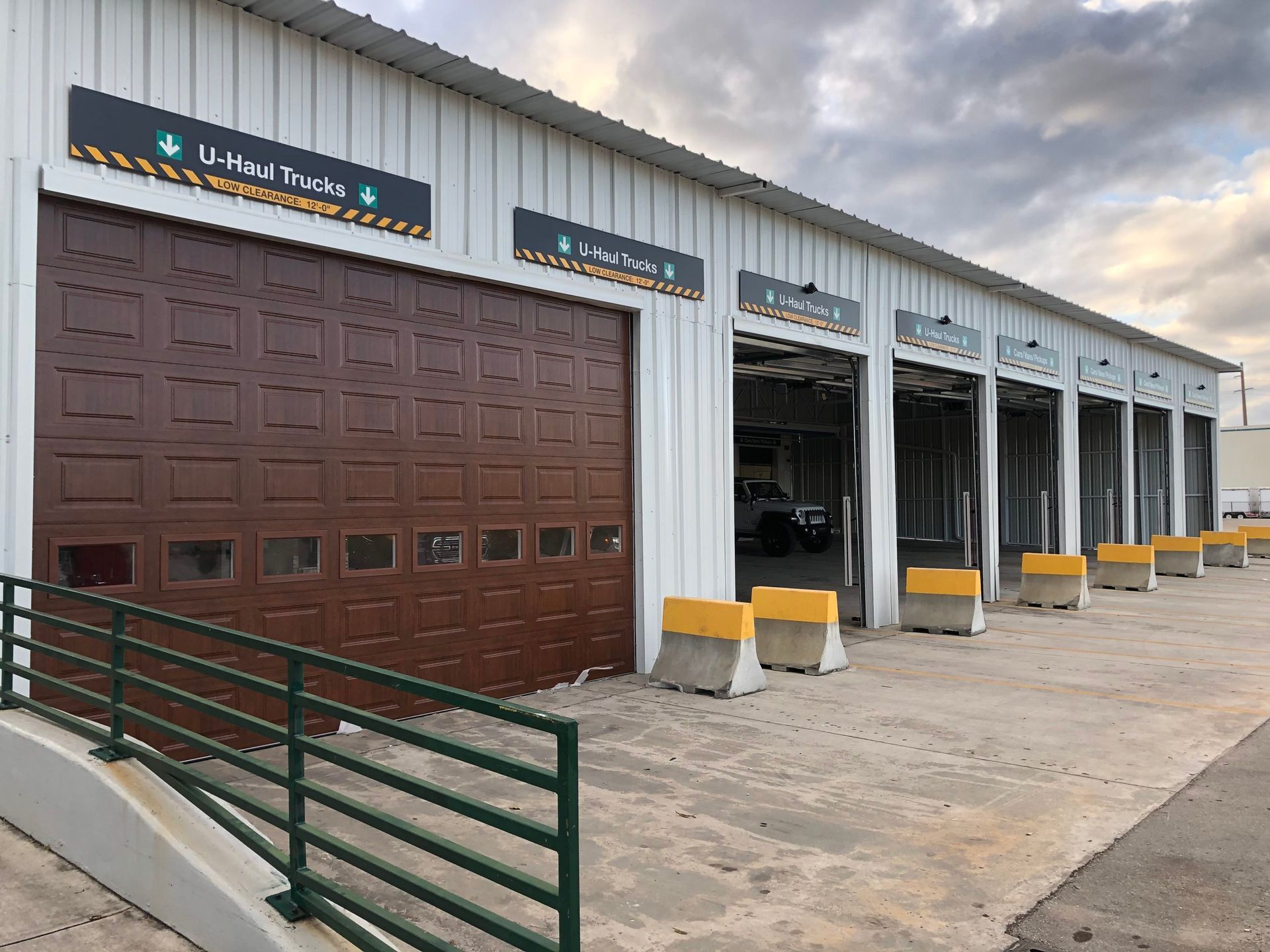 a row of garage doors are lined up in front of a building .