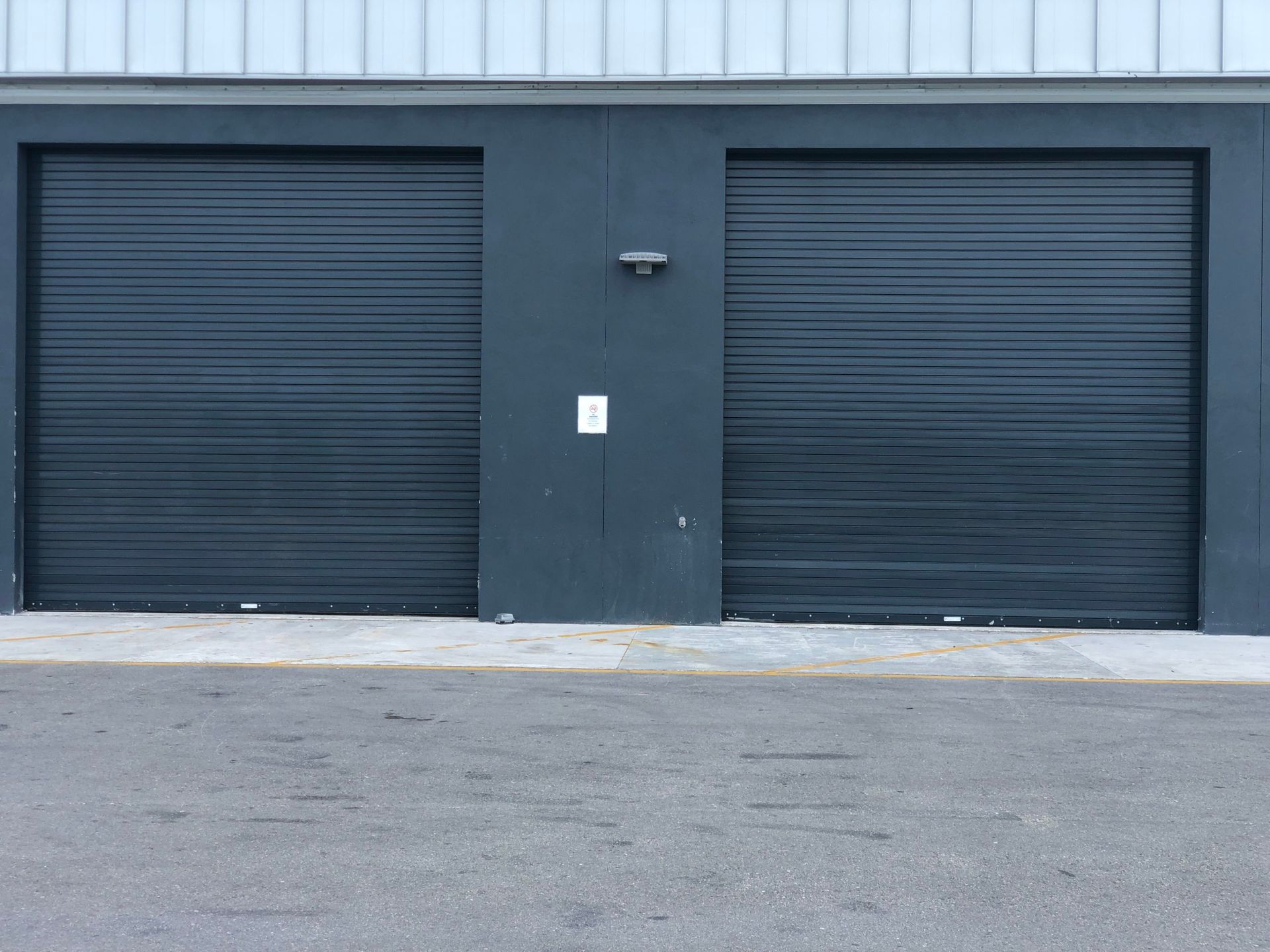 there are two garage doors on the side of a building .