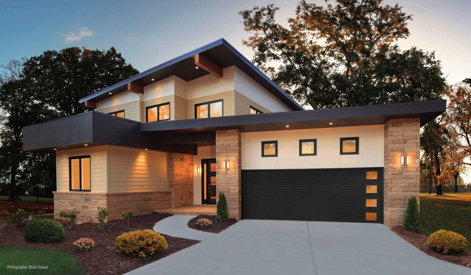 a modern house with a large black garage door