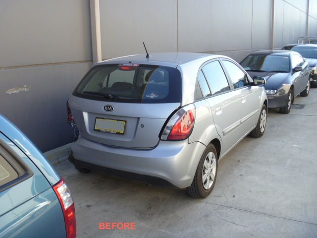A silver car is parked in a parking lot with the word before on the bottom