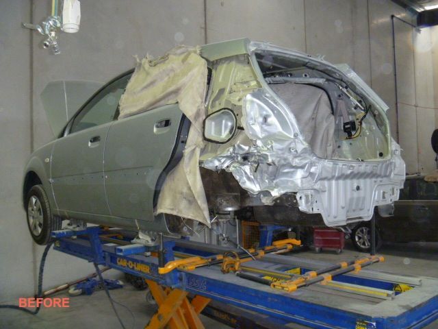 A car is sitting on a lift with the word before on the bottom