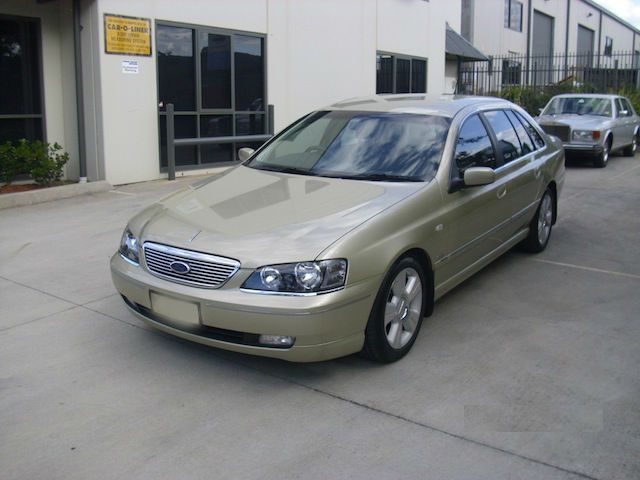 A ford car is parked in front of a building