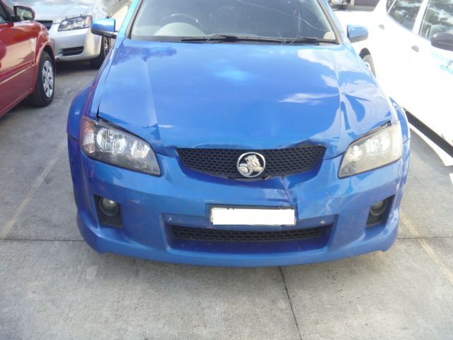 A blue vauxhall car is parked in a parking lot
